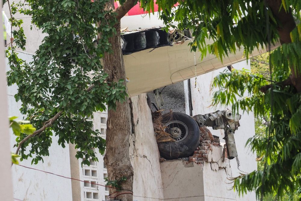 The wreckage of Air India flight 171, including part of the landing gear, is pictured at the site a day after it crashed in a residential area near the airport, in Ahmedabad on June 13, 2025. — AFP pic