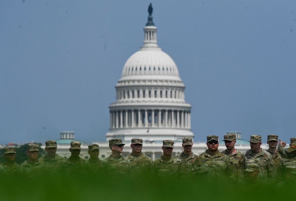 Protests, Middle East tensions and storms may rain on Trump’s birthday parade Soldiers pose for a group photo on the National Mall in Washington. — AFP pic