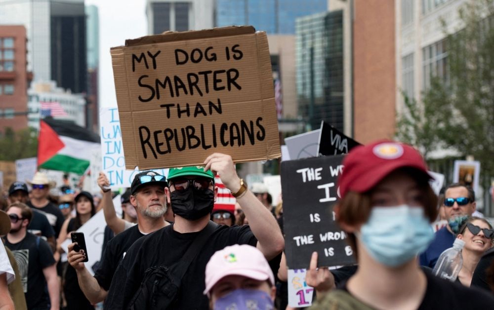 No kings, just quips: Protesters roast Trump with cardboard sass A demonstrator holds sign reading ‘My Dog is Smarter than Republicans’ while protesting the Trump administration during the ‘No Kings’ national rally in Denver June 14, 2025. — AFP pic