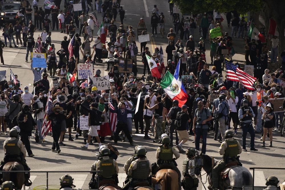 Demonstrators display Mexican and US flags in front of mounted police at a protest against US President Donald Trump’s policies and federal immigration sweeps during a No Kings Day demonstration in Los Angeles, California June 14, 2025. — Reuters pic —