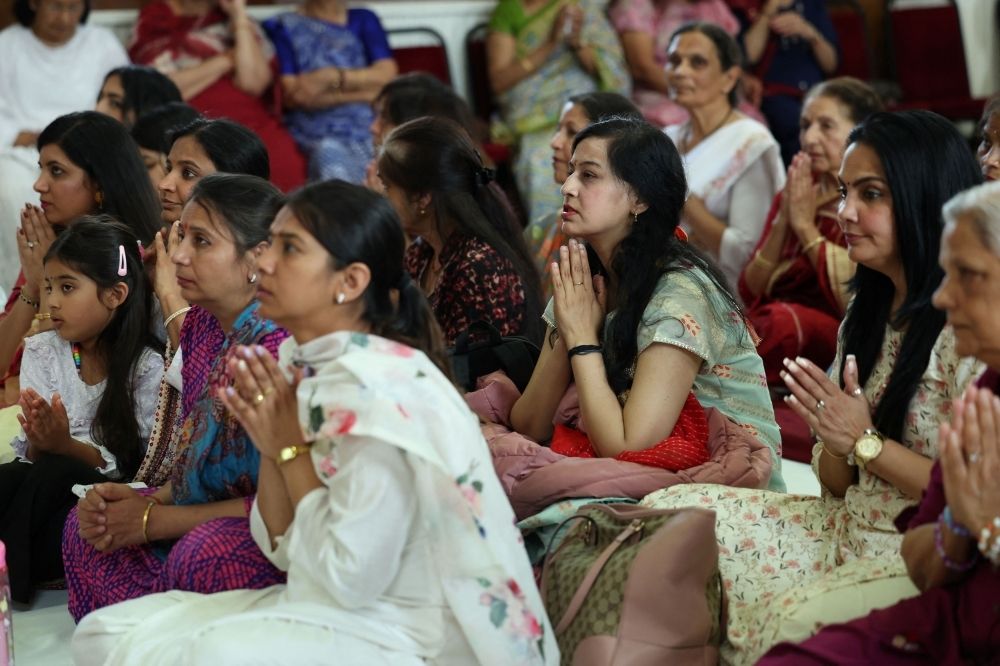 Families mourn as funerals begin for Air India plane crash victims as DNA identification continues Women pray in a vigil at the International Siddhashram Shakti Centre in memory of those who have lost their lives in the Air India crash, in London June 14, 2025. — Reuters pic