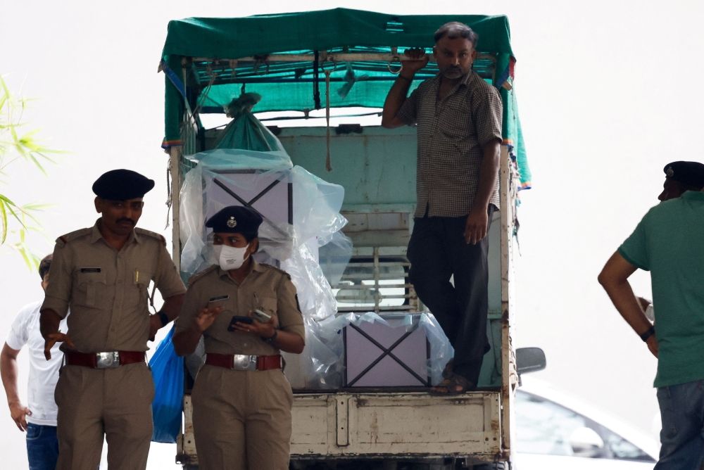 A worker stands inside a vehicle carrying coffins for the victims, who died after the Air India Boeing 787-8 Dreamliner plane bound for London's Gatwick Airport crashed during take-off from Ahmedabad, outside a mortuary at a hospital in Ahmedabad, India, June 14, 2025. — Reuters pic