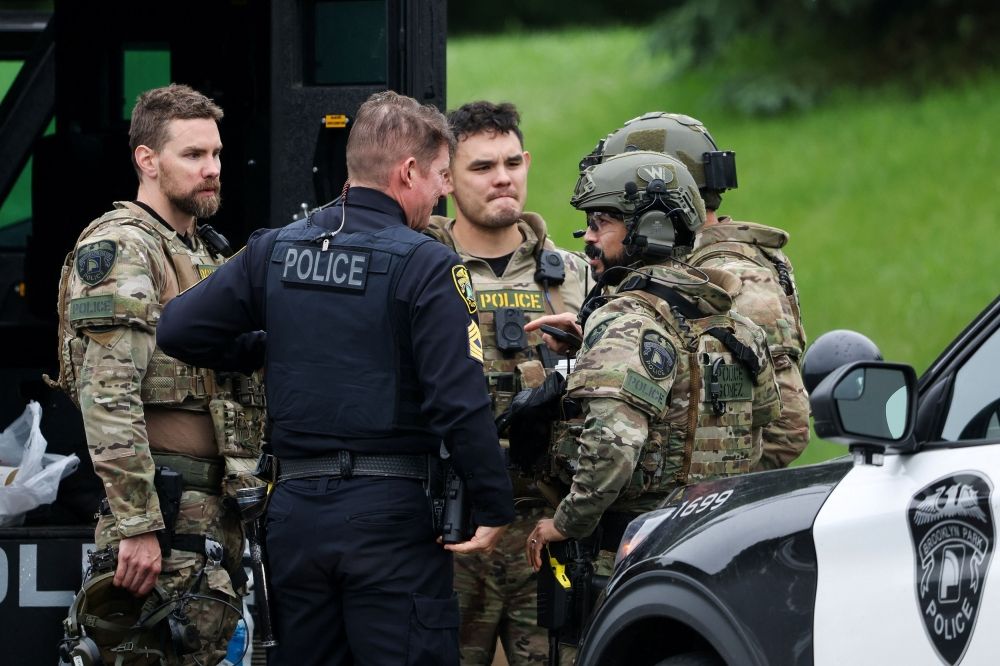 Officers communicate in a staging area after what police said was a targeted shooting in the area around Edinburgh Golf Course in the Minneapolis suburb of Brooklyn Park, Minnesota June 14, 2025. — Reuters pic