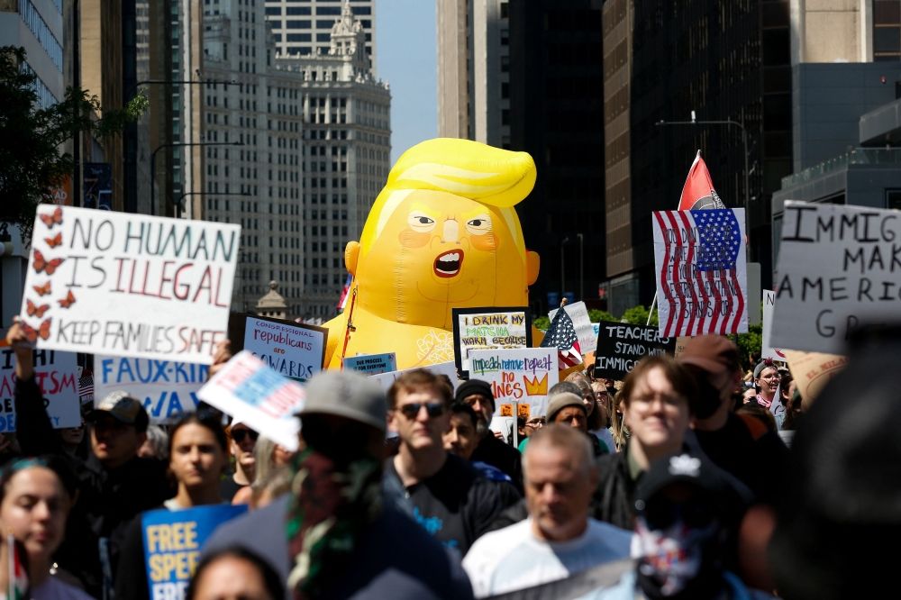 People gather near a balloon depicting US President Donald Trump during the No Kings rally to protest against Trump’s policies in Chicago, Illinois June 14, 2025. — Reuters pic