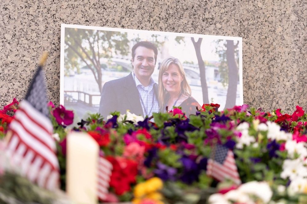 US enforcers nab suspect two days after fatal shooting of Democratic politician and spouse A picture of murdered Democratic state assemblyman Melissa Hortman (right) and her husband Mark is placed in a memorial on June 15, 2025. — Reuters pic