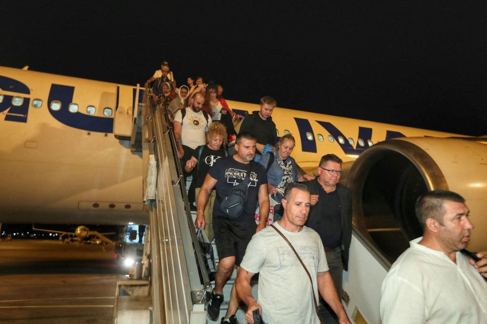 People evacuated from Israel disembark from a plane, amid the Israel-Iran conflict, at Vasil Levski Sofia airport, Sofia, Bulgaria, June 18, 2025. — Bulgarian Foreign Ministry handout pic via Reuters