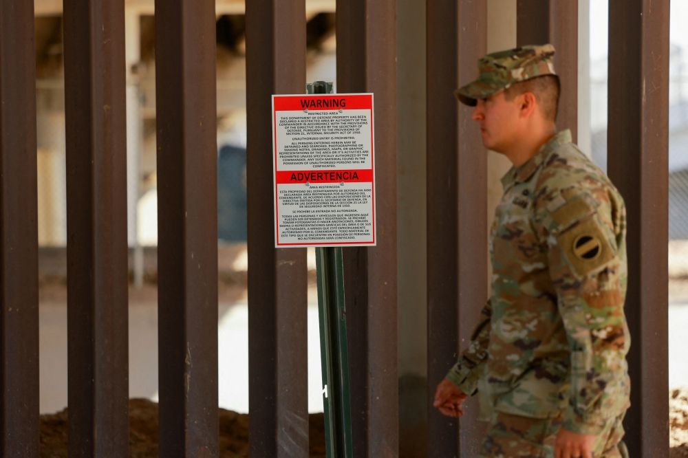 A soldier walks past a warning sign marking a restricted area near the US-Mexico border, as part of the Trump administration’s crackdown on immigration and following the establishment of a 260-mile military zone along the US southern border in New Mexico and Texas, in El Paso, Texas May 22, 2025. — Reuters pic