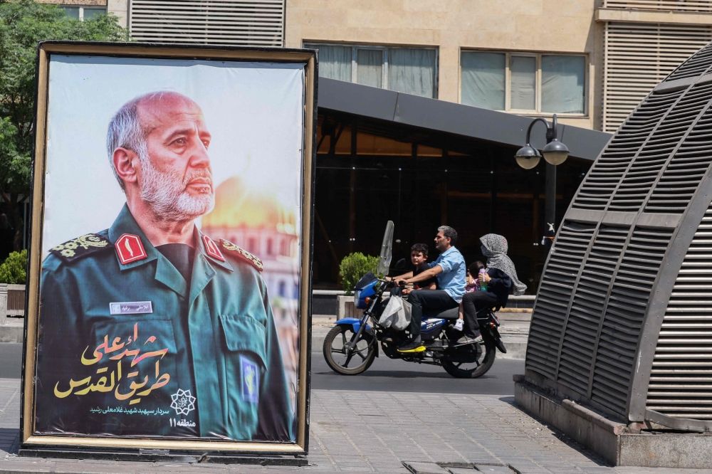 A poster of slain Iranian Islamic Revolutionary Guard Corps (IRGC) commander Gholam Ali Rashid, killed following Israeli strikes on targets in Iran, is set up at a Tehran square on June 16, 2025. — AFP pic