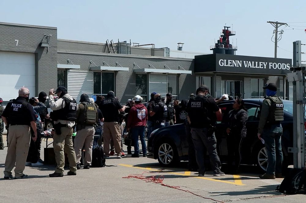 Federal agents stand with workers during a raid by US Immigration and Customs Enforcement (ICE) at a Glenn Valley Foods meat production plant in Omaha, Nebraska June 10, 2025 in a still image from video. — US Immigration and Customs Enforcement handout pic via Reuters
