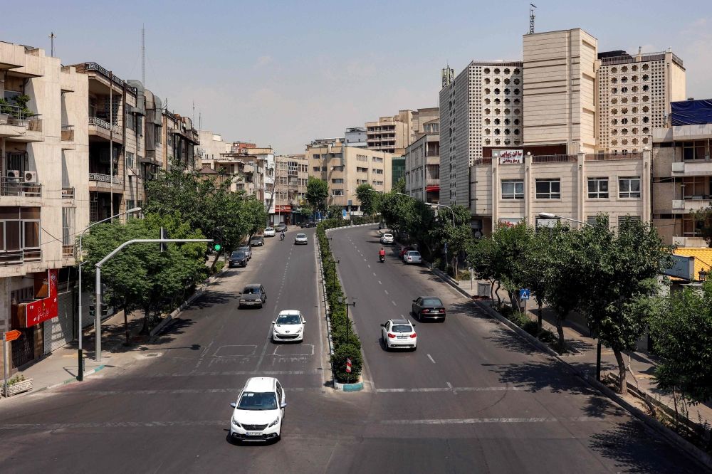 Vehicles move along a street in central Tehran on June 13, 2025. — AFP pic