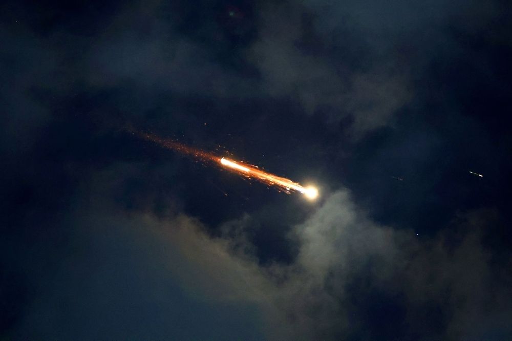 On the brink: Can international talks halt the escalating Israel-Iran conflict? Rocket trails are seen in the sky above the Israeli coastal city of Netanya amid a fresh barrage of Iranian missile attacks on June 21, 2025. — AFP pic