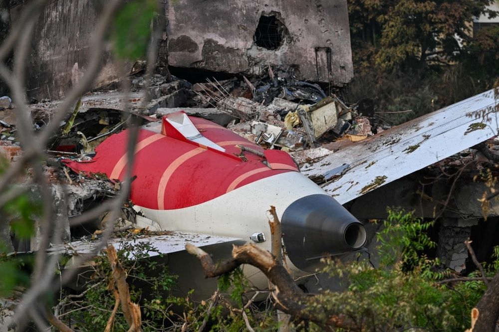 Indian investigators retrieve black box data as search for answers continues after deadly Air India crash Wreckage showing the tail section of the Air India Boeing 787-8 is pictured in a residential area near the airport in Ahmedabad June 14, 2025. — AFP pic