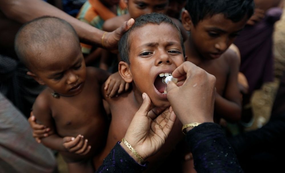 A Rohingya refugee child gets an oral cholera vaccine, distributed by the World Health Organisation (WHO) with the help of volunteers and local NGO's, in a refugee camp near Cox's Bazar, Bangladesh October 11, 2017. — Reuters pic