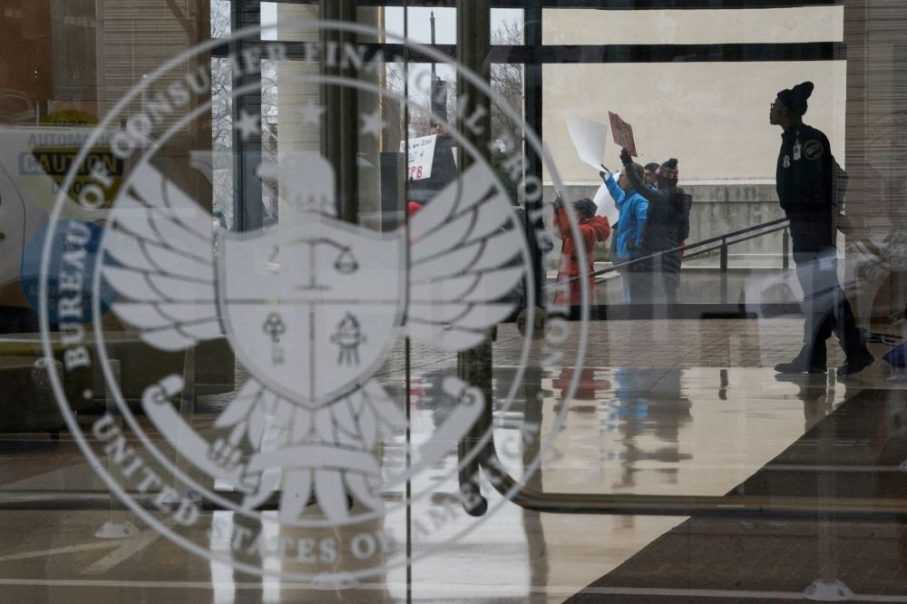 A special police member monitors a protest, while inside the Consumer Financial Protection Bureau (CFPB) building, the day after members of Elon Musk's Department of Government Efficiency (DOGE) moved into the CFPB, in Washington February 8, 2025. — Reuters pic