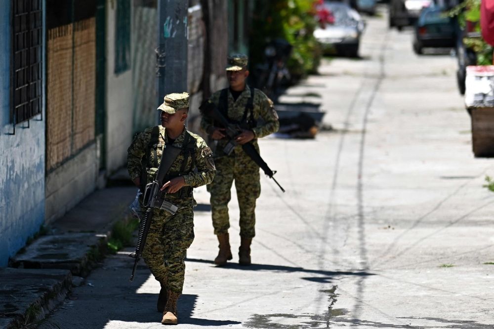 Slushies and slayings: El Salvador’s state of emergency brings peace, but survivors still haunted by MS-13 gang past Two soldiers patrol the 10 de Octubre residential neighbourhood in San Marcos, El Salvador, on June 14, 2025. — AFP pic