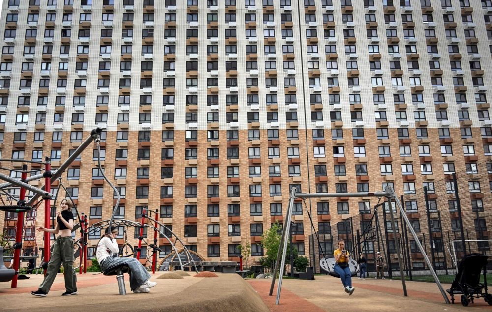 Children enjoy their time in front of a newly built apartment building in the edge of Moscow on June 11, 2025. — AFP pic