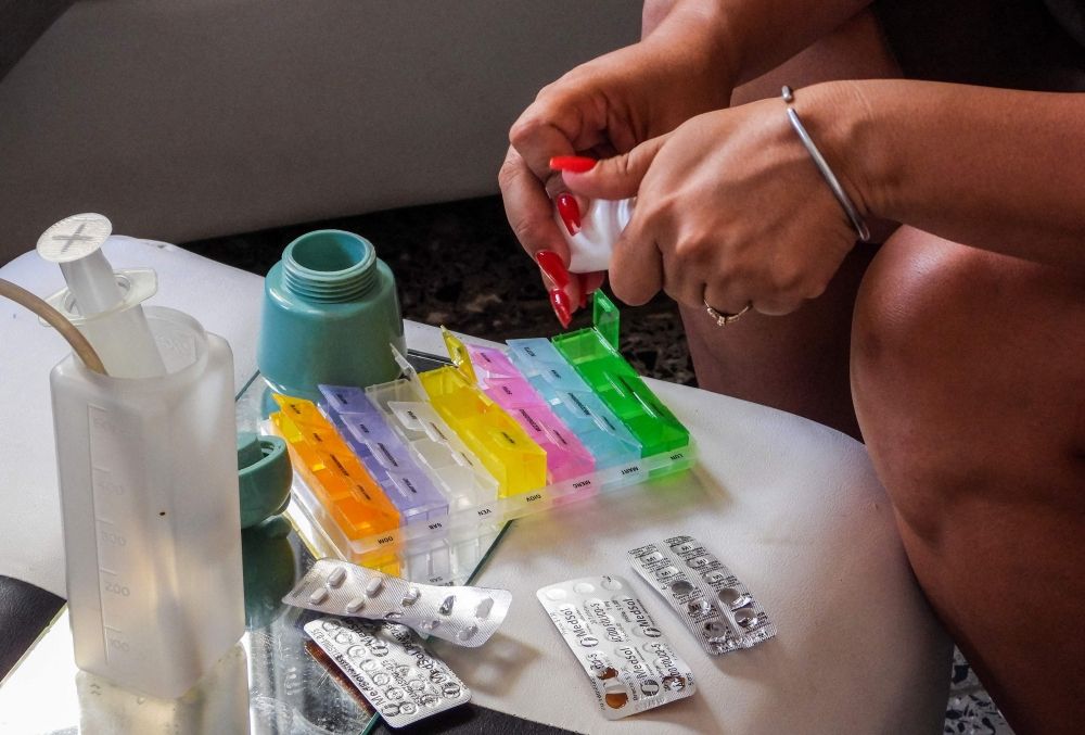 Jessica Rodriguez Romero prepares medicines to administer with a syringe directly into the stomach of her son, Luis Angelo, due to his tracheostomy, at their home in the Santa Fe neighbourhood of Havana July 2, 2025. — AFP pic