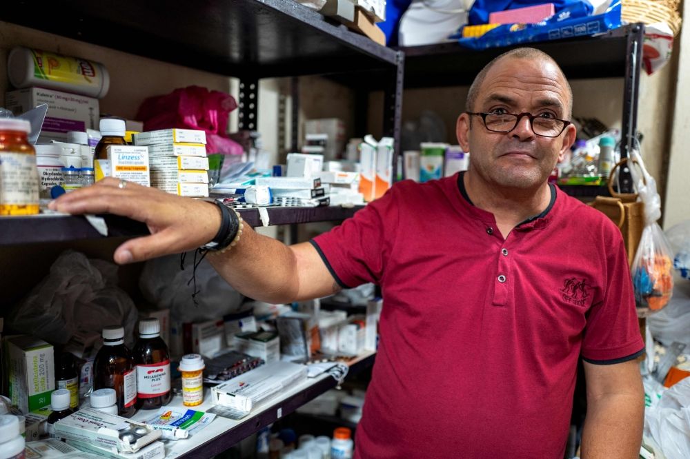 Sergio Cabrera, coordinator of the humanitarian project Palomas, shows the list of free medicines available as a result of donations and exchanges among users of his WhatsApp group, in Havana April 28, 2025. — AFP pic