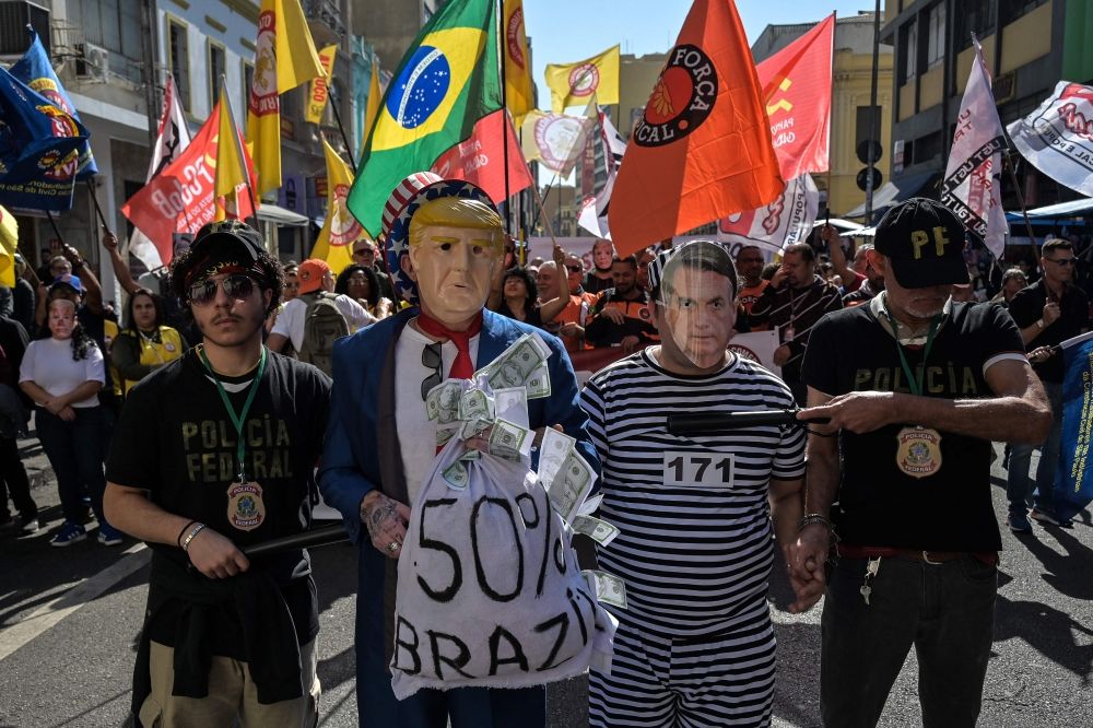 Protesters wearing masks depicting US President Donald Trump and former Brazilian president Jair Bolsonaro take part in a protest in defence of retail employment and national sovereignty at 25 de Marco, a popular shopping street in downtown Sao Paulo, Brazil, on July 18, 2025. — AFP pic Protesters wearing masks depicting US President Donald Trump and former Brazilian president Jair Bolsonaro take part in a protest in defence of retail employment and national sovereignty at 25 de Marco, a popular shopping street in downtown Sao Paulo, Brazil, on July 18, 2025. — AFP pic