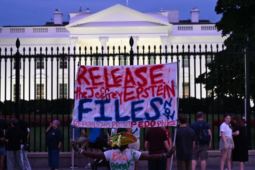 A protester holds a sign outside the White House demanding the release to all files related to Jeffrey Epstein in Washington, DC, on July 18, 2025. — AFP pic A protester holds a sign outside the White House demanding the release to all files related to Jeffrey Epstein in Washington, DC, on July 18, 2025. — AFP pic