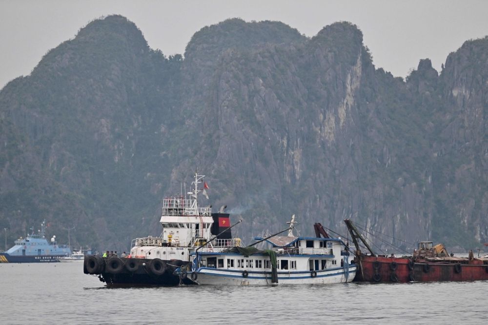 Ha Long Bay deaths: Investigation underway as victims’ families seek answers The tourist boat (centre) that capsized is towed back to the port in Ha Long bay, Quang Ninh province on July 20, 2025. — AFP pic