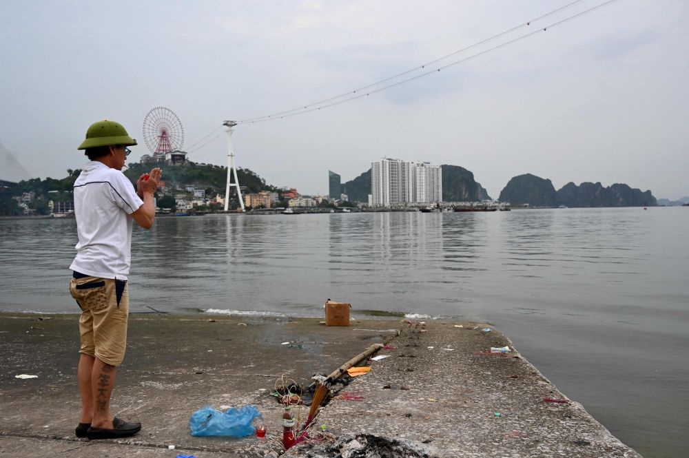 A man prays for the victims of a capsized tourist boat in Ha Long Bay, Quang Ninh Province on July 20, 2025. — AFP pic A man prays for the victims of a capsized tourist boat in Ha Long Bay, Quang Ninh Province on July 20, 2025. — AFP pic