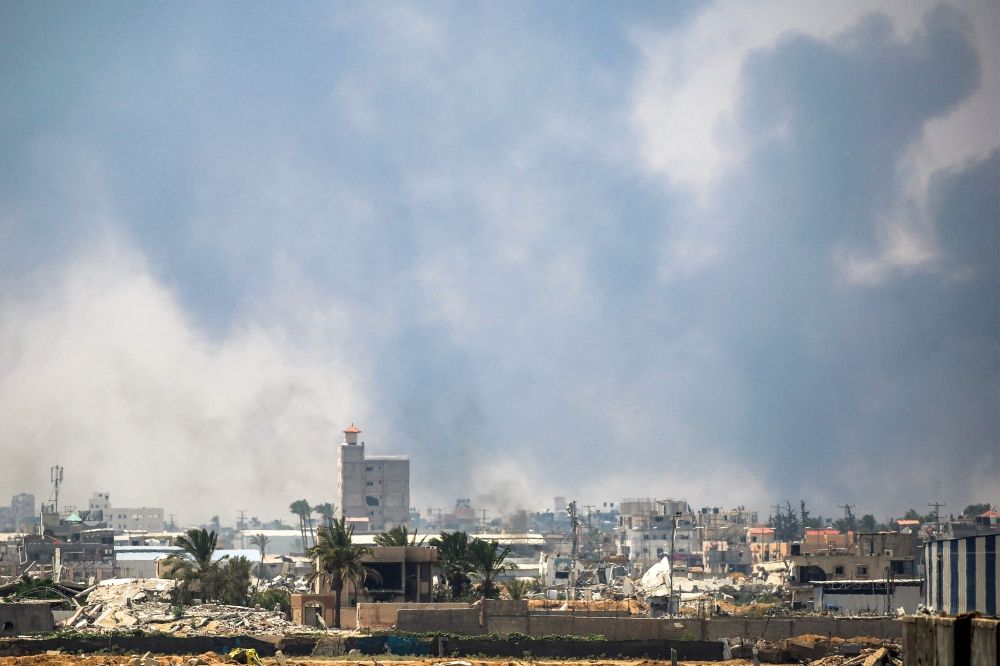 Smoke billows from Israeli bombardment as pictured from Deir el-Balah in the central Gaza Strip on July 21, 2025. — AFP pic Smoke billows from Israeli bombardment as pictured from Deir el-Balah in the central Gaza Strip on July 21, 2025. — AFP pic