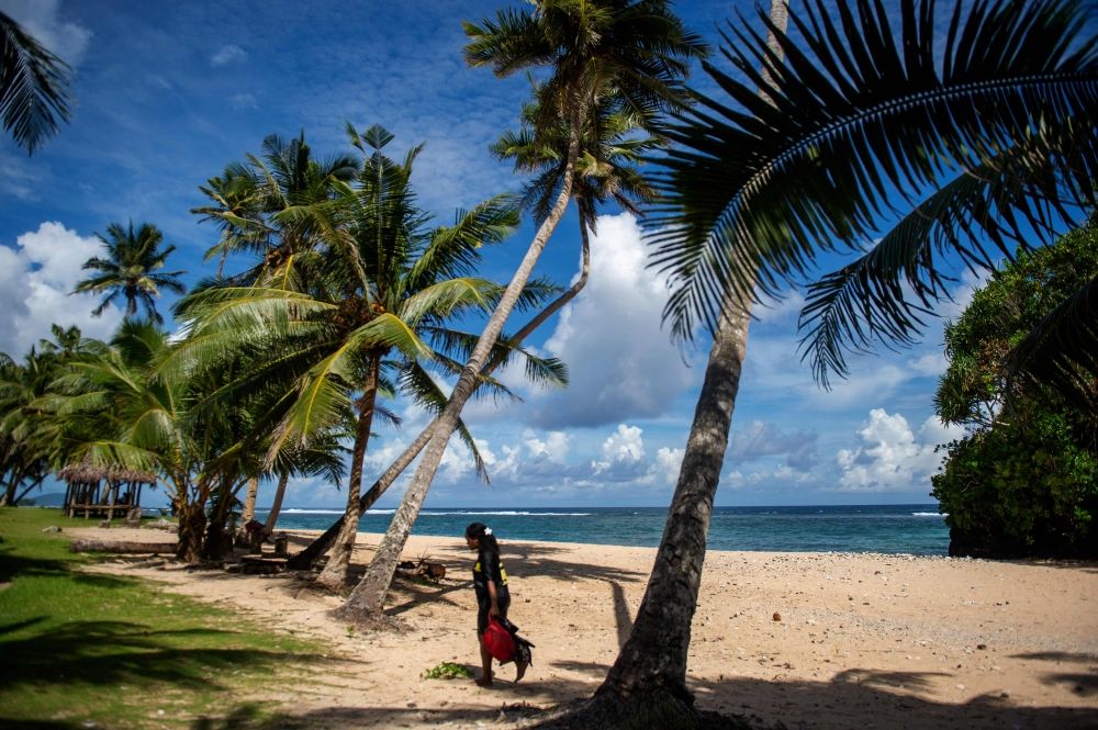 This picture taken on March 23, 2025 shows a resident walking along the Vavau Beach in Samoa on an autumn morning. The world's top court is poised to tell governments what their legal obligations are to tackle global warming, and possibly outline consequences for polluters that cause climate harm to vulnerable countries. — AFP pic This picture taken on March 23, 2025 shows a resident walking along the Vavau Beach in Samoa on an autumn morning. The world's top court is poised to tell governments what their legal obligations are to tackle global warming, and possibly outline consequences for polluters that cause climate harm to vulnerable countries. — AFP pic