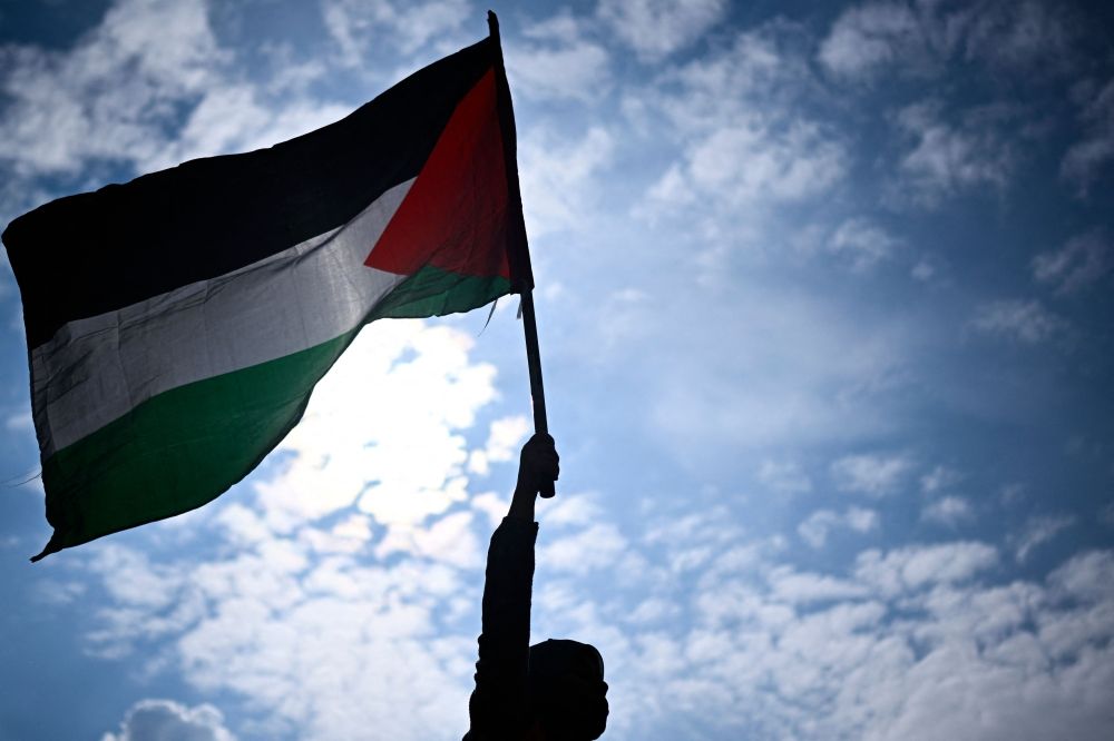 A protester holds a Palestinian flag during a rally called by several French organisations in support of Palestinian people at Place de la Republique in Paris on May 7, 2024. — AFP pic A protester holds a Palestinian flag during a rally called by several French organisations in support of Palestinian people at Place de la Republique in Paris on May 7, 2024. — AFP pic