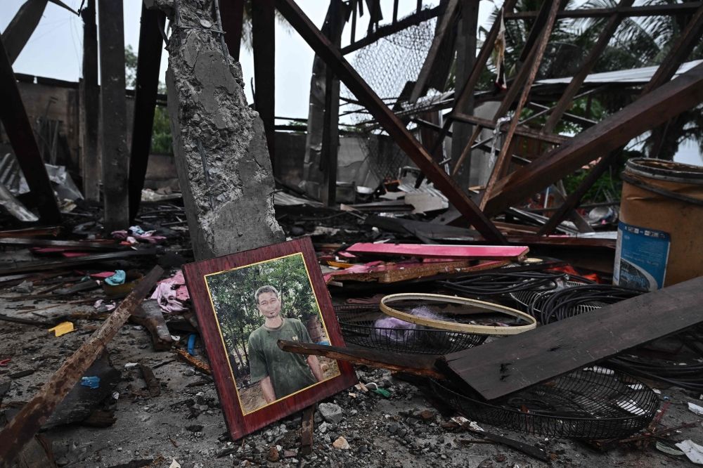 A portrait lies in an evacuated house that was destroyed by fire after being hit by Cambodian artillery that morning, in the Thai border province of Surin on July 27, 2025. — AFP pic A portrait lies in an evacuated house that was destroyed by fire after being hit by Cambodian artillery that morning, in the Thai border province of Surin on July 27, 2025. — AFP pic