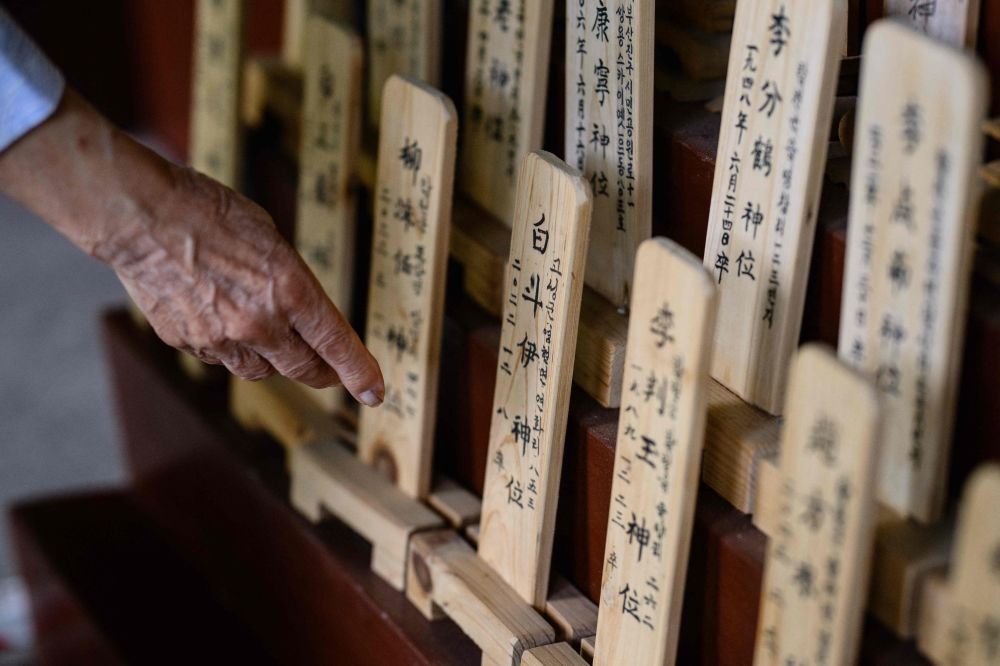 This photo shows Hiroshima atomic bomb survivor Bae Kyung-mi reaching out while visiting a traditional structure holding wooden plaques bearing the names of deceased victims behind the Hapcheon Atomic Bomb Victim Welfare Center. — AFP pic This photo shows Hiroshima atomic bomb survivor Bae Kyung-mi reaching out while visiting a traditional structure holding wooden plaques bearing the names of deceased victims behind the Hapcheon Atomic Bomb Victim Welfare Center. — AFP pic