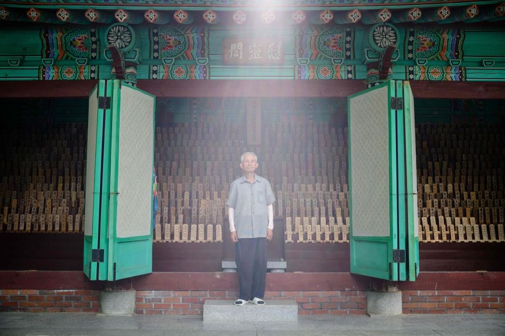 This photo taken in Hapcheon, South Gyeongsang, shows Lee Bu-yul, 87, a survivor of the US atomic bombing of Hiroshima during World War II, posing in front of a traditional structure holding 1,172 wooden plaques bearing the names of deceased victims behind the Hapcheon Atomic Bomb Victim Welfare Center. Lee was seven at the time of the Hiroshima atomic bombing and his mother died within one year of it. — AFP pic This photo taken in Hapcheon, South Gyeongsang, shows Lee Bu-yul, 87, a survivor of the US atomic bombing of Hiroshima during World War II, posing in front of a traditional structure holding 1,172 wooden plaques bearing the names of deceased victims behind the Hapcheon Atomic Bomb Victim Welfare Center. Lee was seven at the time of the Hiroshima atomic bombing and his mother died within one year of it. — AFP pic
