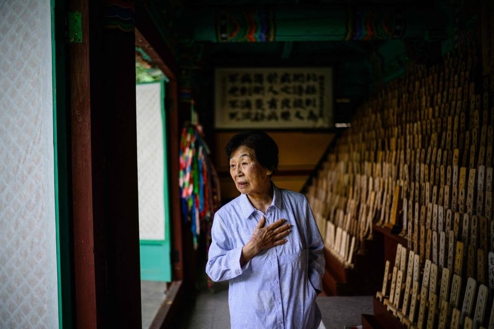 Decades later, Korean survivors of WWII atomic bombs still carry the scars, and the silence This photo taken in Hapcheon, South Gyeongsang, about 320km south of Seoul on July 10, 2025 shows Hiroshima atomic bomb survivor Bae Kyung-mi reacting while visiting a traditional structure holding 1,172 wooden plaques bearing the names of deceased victims — among them Bae’s three siblings — behind the Hapcheon Atomic Bomb Victim Welfare Center, opened in 1996 by the Korean Red Cross with funding from both South Korean and Japanese governments, providing round-the-clock service to survivors of the World War II atomic bombings seeking help. — AFP pic