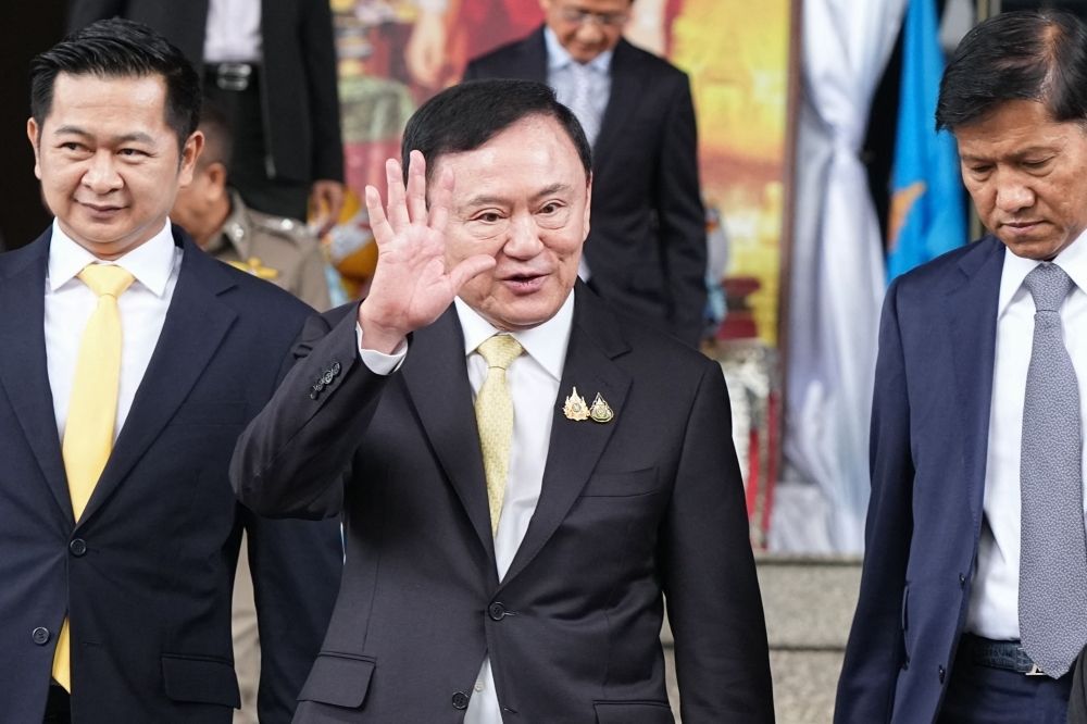 Bangkok court acquits Thaksin in lese-majeste case, but Shinawatra dynasty still under fire as daughter’s fate looms Thaksin (centre) and his lawyer Winyat Chatmontree (left) leave the Criminal Court in Bangkok on August 22, 2025 after a Thai court acquitted the former prime minister of royal defamation charges. — AFP pic