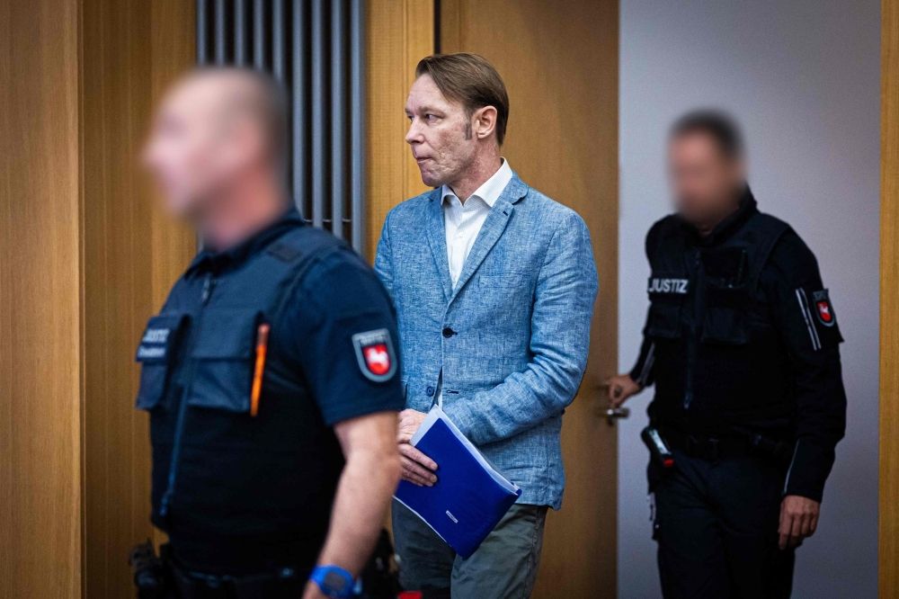 Madeleine McCann case: Prosecutors on edge as main suspect Christian Brueckner nears release, concerns mount he could flee Germany Defendant Christian B. (C) is brought to the courtroom for a session of his trial at court in Braunschweig, northern Germany, on September 25, 2024. — AFP pic