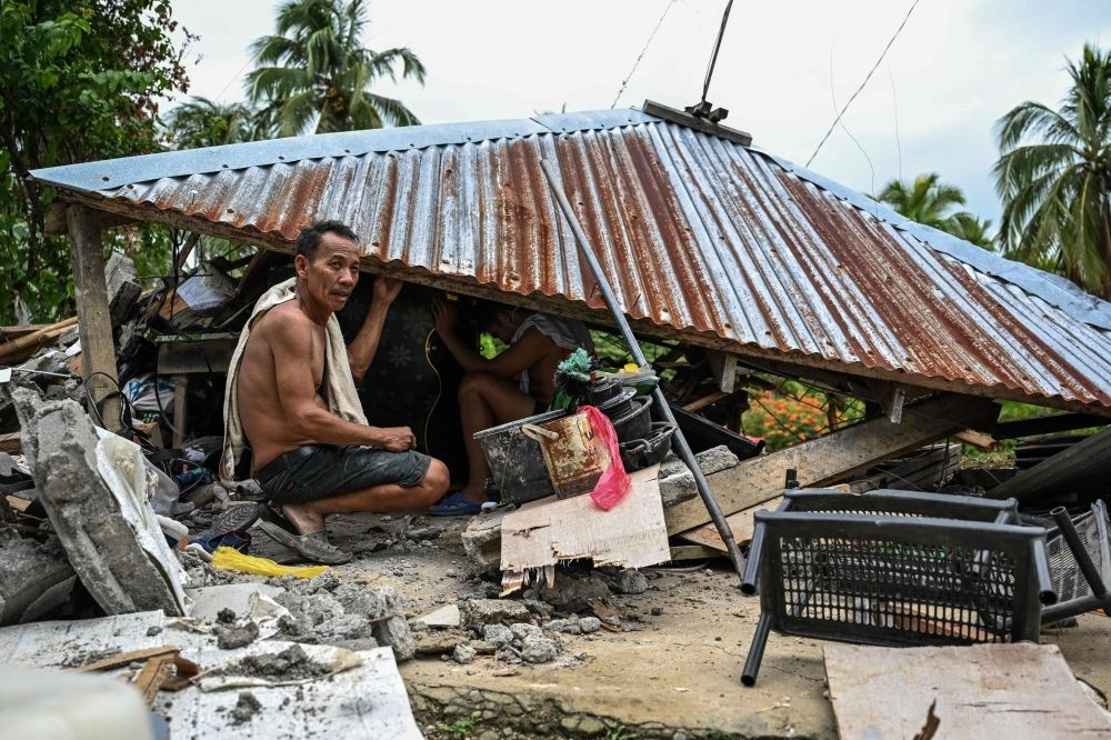 Picking up the pieces: Philippines residents start rebuilding lives after deadly quakes Men search for belongings inside a collapsed house in Manay, Davao Oriental, on October 11, 2025, a day after two powerful offshore earthquakes struck the southern Philippines and killed at least eight people. — AFP pic