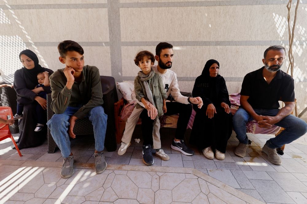 Freed Palestinian detainee Shadi Abu Sido sits with his relatives at their home in Nuseirat, central Gaza Strip, on October 14, 2025, after his release from Israeli detention as part of a ceasefire deal between Hamas and Israel. — Reuters pic Freed Palestinian detainee Shadi Abu Sido sits with his relatives at their home in Nuseirat, central Gaza Strip, on October 14, 2025, after his release from Israeli detention as part of a ceasefire deal between Hamas and Israel. — Reuters pic