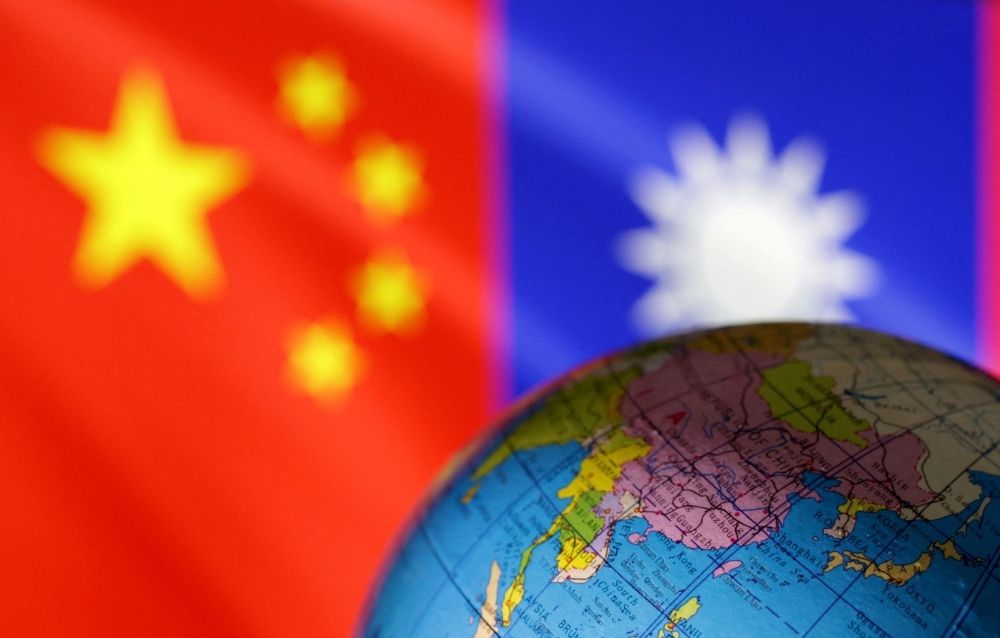 ‘Who is this?’ Taiwan’s KMT brushes off Chinese election interference claims following Xi’s reunification message A globe is seen in front of Chinese and Taiwanese flags in this illustration from August 6, 2022. — Reuters pic