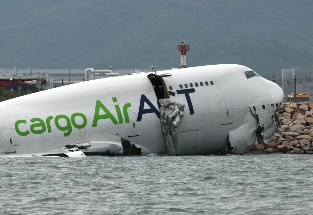 A cargo plane lies partially in the sea after veering off the runway during landing at Hong Kong International Airport in Hong Kong October 20, 2025. — Reuters pic A cargo plane lies partially in the sea after veering off the runway during landing at Hong Kong International Airport in Hong Kong October 20, 2025. — Reuters pic