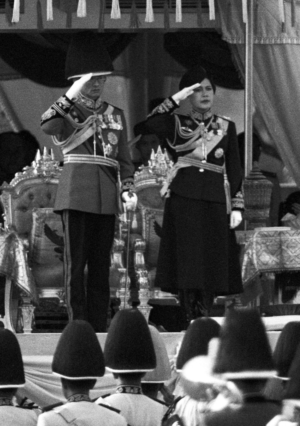 Thai King Bhumibol Adulyadej and Queen Sirikit salute as they review a guard of honour unit during a military parade in Bangkok December 3, 1989. — Reuters pic Thai King Bhumibol Adulyadej and Queen Sirikit salute as they review a guard of honour unit during a military parade in Bangkok December 3, 1989. — Reuters pic
