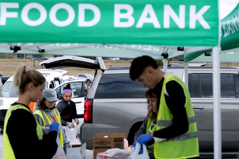 US Supreme Court allows Trump administration to withhold US$4b in food aid for 42 million Americans — for now Volunteers place food items in vehicles during a mobile food distribution at Cedar Creek High School, as nearly 42 million Americans face a potential lapse in Supplemental Nutrition Assistance Programme (SNAP) benefits, known as food stamps, due to the second-longest US government shutdown, in Cedar Creek, Texas November 1, 2025. — Reuters pic