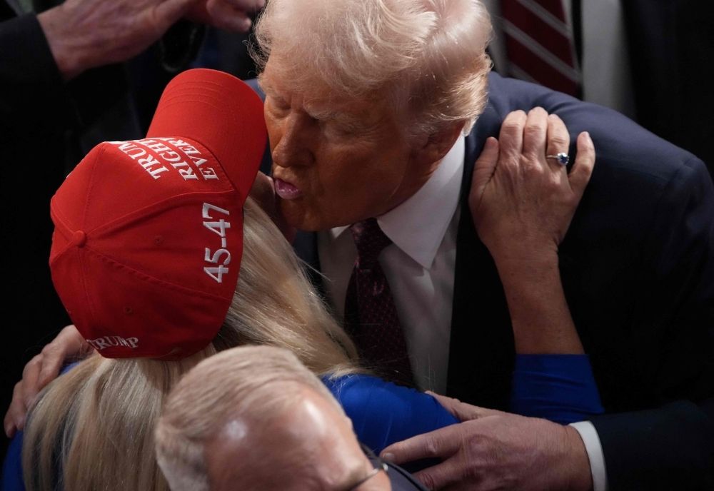 From ally to target: US lawmaker Greene blames Trump for death threats from radicalised men as feud erupts Trump kisses Republican Marjorie Taylor Greene (R-GA) after addressing a joint session of Congress at the US Capitol on March 04, 2025 in Washington, DC. — AFP pic