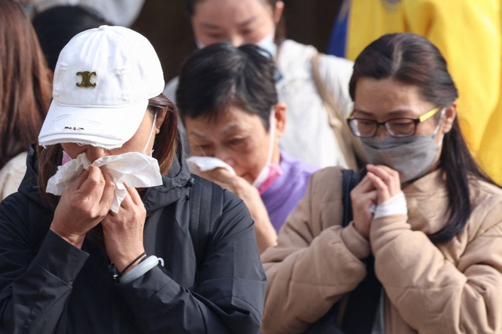 Relatives react after identifying family members from photos at Kwong Fuk Community Hall following the Wang Fuk Court housing estate fire, in Tai Po, Hong Kong, China, November 27, 2025. — Reuters pic Relatives react after identifying family members from photos at Kwong Fuk Community Hall following the Wang Fuk Court housing estate fire, in Tai Po, Hong Kong, China, November 27, 2025. — Reuters pic