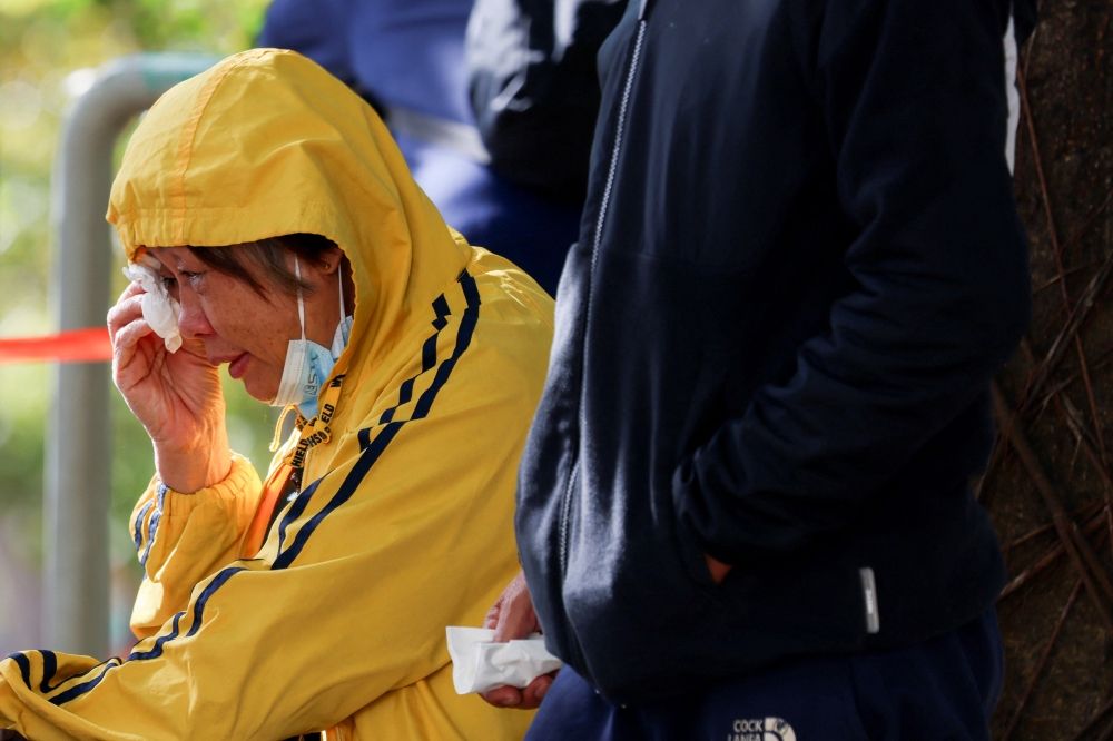 A woman reacts outside the Kwong Fuk Community Hall, where relatives identify family members from photos, following the Wang Fuk Court housing complex fire, in Tai Po, Hong Kong, China, on November 28, 2025. — Reuters pic A woman reacts outside the Kwong Fuk Community Hall, where relatives identify family members from photos, following the Wang Fuk Court housing complex fire, in Tai Po, Hong Kong, China, on November 28, 2025. — Reuters pic