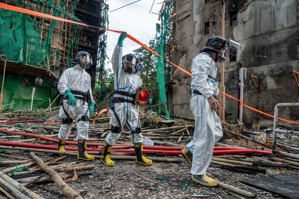 Hong Kong scrambles to remove scaffolding nets after deadly fire; contractors to foot bill Officers from the Disaster Victim Identification Unit enter the disaster scene Wang Fuk Apartments in Hong Kong on December 1, 2025 after a deadly fire that killed over 150 people so far. — Handout picture by the Hong Kong Police Force/AFP