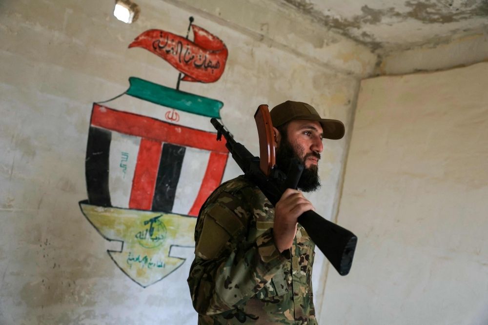 ‘It’s all over’: How Iran left Assad to his fate just days before Damascus fell A soldier from the Syrian Ministry of Defense stands next a mural during a tour in an abandoned military base, once considered to be the largest Iranian military base in Syria, on the southern outskirts of Aleppo, in the Jabal Azzan area on December 4, 2025. — AFP pic