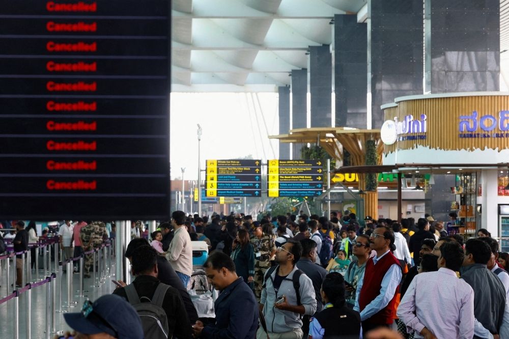 What are India’s pilot safety rules that hit IndiGo operations and air travel Travellers look at updates on flights, as they stand next to a screen displaying details of cancelled IndiGo airlines flights, at Kempegowda International Airport in Bengaluru December 6, 2025. — Reuters pic