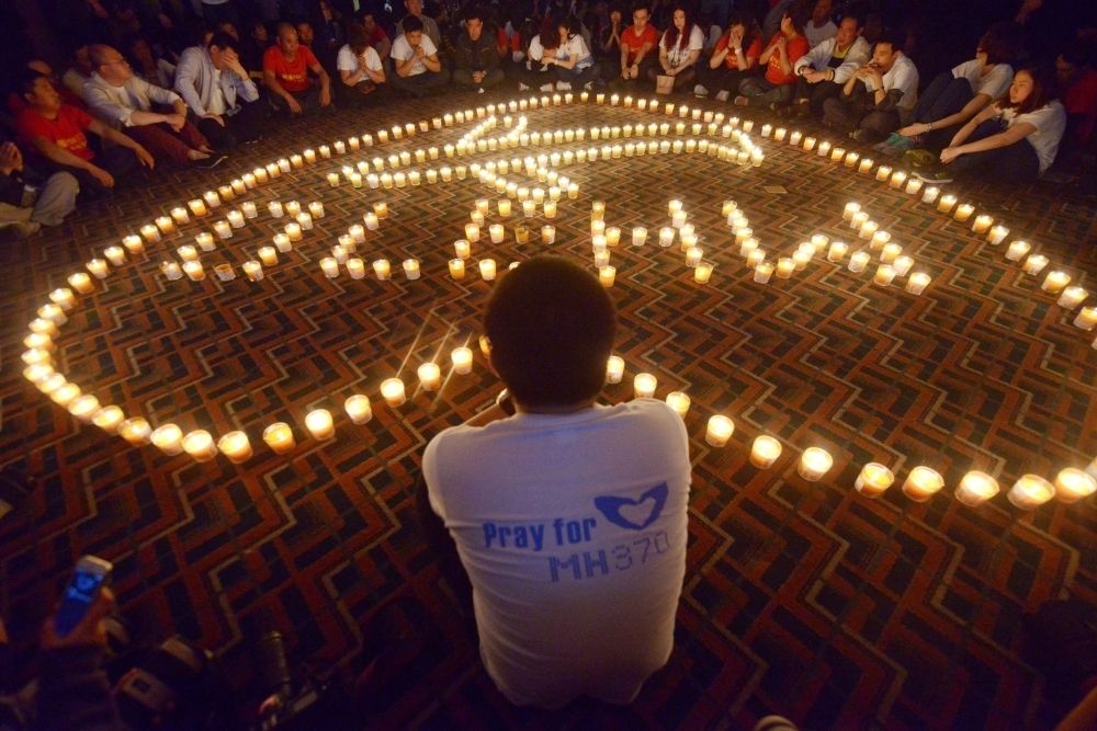 Chinese relatives of passengers on the missing Malaysia Airlines flight MH370 take part in a prayer service at the Metro Park Hotel in Beijing on April 8, 2014. — AFP pic