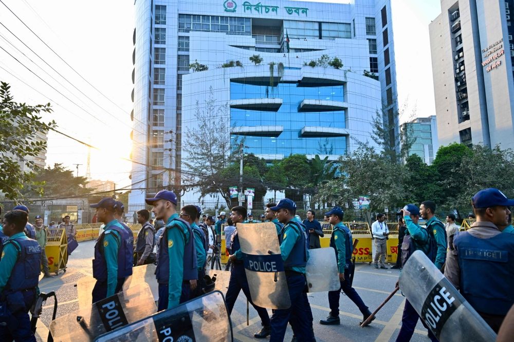 Bangladesh police personnel stand guard outside the Election Commission’s office in Dhaka on December 11, 2025, ahead of the announcement of the parliamentary elections and the July National Charter referendum. — AFP pic Bangladesh police personnel stand guard outside the Election Commission’s office in Dhaka on December 11, 2025, ahead of the announcement of the parliamentary elections and the July National Charter referendum. — AFP pic