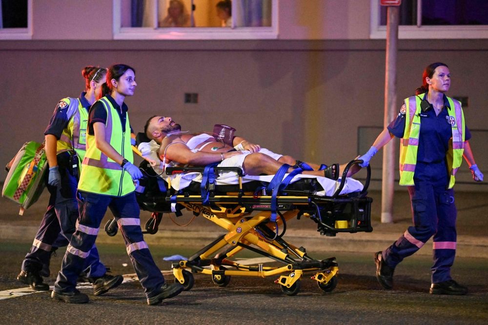 Health workers wheel a wounded man to an ambulance after a shooting at Sydney’s Bondi Beach on December 14, 2025. — AFP pic Health workers wheel a wounded man to an ambulance after a shooting at Sydney’s Bondi Beach on December 14, 2025. — AFP pic